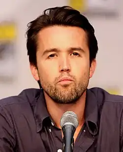 Rob McElhenney behind a microphone