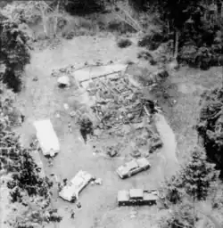 Overhead black and white shot of a house burnt to rubble