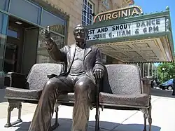 An image of a bronze statue of Roger Ebert outside of a movie theater.