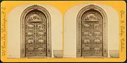 Two arched engraved bronze doors.