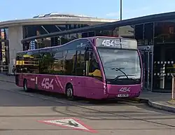 Rosso Optare Versa (second facelift) on route 464 at Rochdale Interchange, July 2025.