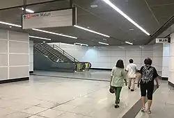Escalators at concourse paid area to the linkway.