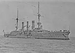 A large ship with two masts and three smokestacks