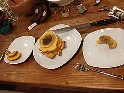 The cake (center) served onto plates (right and left) showing characteristic cake layers resembling growth rings of trees