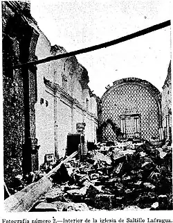 The interior of a church reveals outer walls still standing, while the floor is strewn with rubble from the collapsed roof above, leaving the space open to the sky.