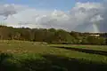 Sandleford Priory, and rainbow, and part of High Wood, from the old carriage track to the west, near Gorse Covert, 2015.