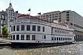 The rear of the hotel spanning River Street, with the Savannah River Queen in the foreground