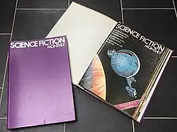 Two magazine binders, one open to show the front page of the first magazine