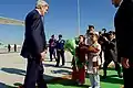 John Kerry approaches two children bearing a traditional greeting of bread and salt as he arrives at Ashgabat International Airport in Ashgabat, Turkmenistan, on November 3, 2015