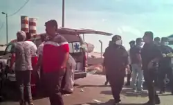 Medical staff standing by an ambulance while patients are being put in it