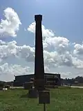 The remaining smoke stack from the machine shop.