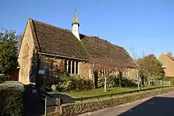 Building with arched window and small turret.