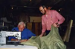 The Dutch sailmaker Henk de Boer at work, assisted by his "Schieman"