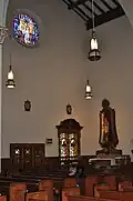 A view of the confessionals and statue of Mary and Jesus just to the side of the main altar