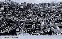 Boat Quay during its heyday around 1865, when as many as 150 boats moored on the river, trading everything from rubber, tin and iron, to silk, porcelain, rice, opium, spices and coffee.[1]