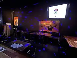 Photograph of the interior of a bar, with chairs and tables