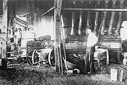 80 ton copper furnace (1900), also showing ladle pushcarts used to hold the copper matte that would be run off from the tapping spout.