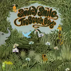 An illustration of an area with excessive greenery occupied by a few smiling animals. In the distance is a small boutique with a smile displayed above its door; chimney smoke spells out the album's title.