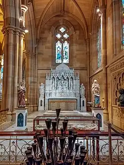 Chapel of the Irish Saints with reredos depicting the Crucifixion, flanked by statues of St Patrick and Brigid of Ireland.
