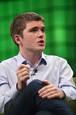 Collison sitting on-stage at Web Summit