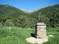 Iron Cross overlooking the upper valley of the Coumelade