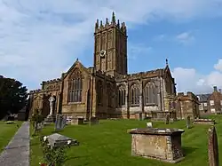 Elaborately ornamented stone building with square tower.