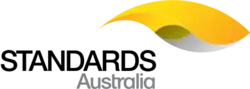 The Standards Australia logo, consisting of the words "Standards Australia" in black and grey capital letters, with a yellow and grey graphic to the top-right of the text.