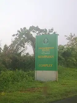 Green signboard showing Sungai Tujoh Milepost Checkpoint