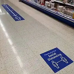 Social distancing floor signs in an Irish supermarket in August 2020.