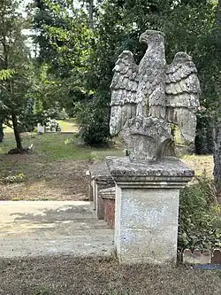 Stone staircase from the Victorian house, later crowned with an eagle statue. Duncan Mackenzie appears in a period photograph right on this spot.