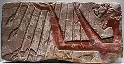 Talatat block with Akhenaton standing to the right, raising his hands in prayer to the rays of the sun god Aten; circa 1350 BC; painted sandstone; from Karnak; Egyptian Museum of Berlin