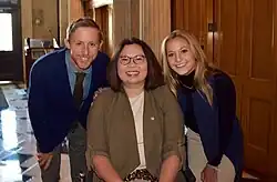 Three people smiling at the camera