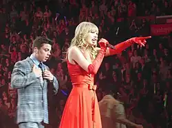 Swift singing while wearing full-red