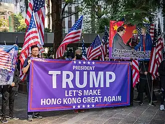 Protesters holding a sign saying "Let's make Hong Kong great again"