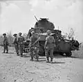 Men of the 2nd Dorsetshires passing a knocked out Lee tank at Mount Popa, April 1945