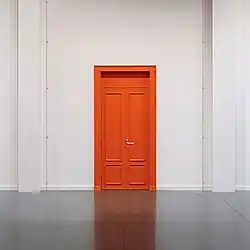 A photo of a large orange door in the distance