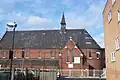 The former Lady Margaret Church, Chatham Street, Southwark, London, built for the St John's College (Cambridge) Mission in 1888–89 by Ewan Christian, now used as the Order of Cherubim and Seraphim Church. Red brick Early English style with typical lancets and apse[167]