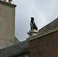 The "Girnin Dug" statue of a dog erected as a reproach to a neighbour suspected of poisoning the pet[40]