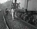 Robbers walking away from the uncoupled train cars