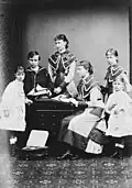 The Hessian children in July 1878. Left to right: Princess Alix, standing; Prince Ernest Louis, standing, sailor suit, holding model yacht; Princess Elizabeth, standing; Princess Victoria, seated; Princess Irene, standing; Princess Marie, standing in front of Irene.