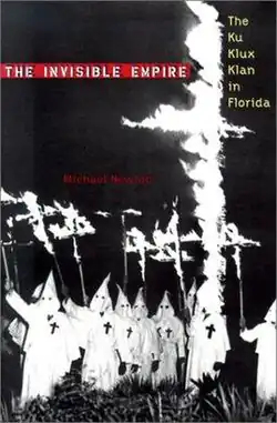 Cover of the book showing many KKK members holding burning crosses