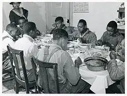 A dinner in Tally Ho, Stem, for African American tenants and neighbors after a day of corn shucking, 1939