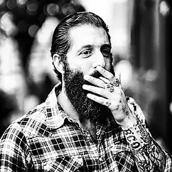 Image 107A man with sleeve tattoos, beard and flannel shirt, mid 2010s (from 2010s in fashion)
