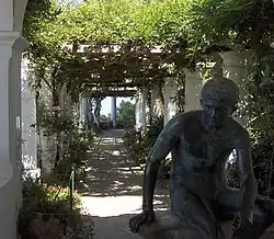 Pergola with Roman statue