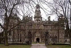 Thoresby Hall and adjoining outbuildings, gate and railings