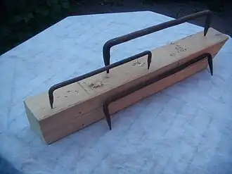 Log dogs are used to hold timbers in place while hewing or as a repair to timber frame joints.