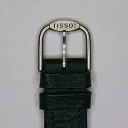 A buckle fastening for a leather watch strap.