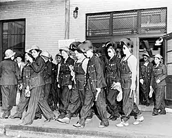 Women welders on the way to their job at the Todd Erie Basin dry dock, circa 1943