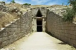 A large, monumental tomb, with a straight passageway leading to a huge doorway.