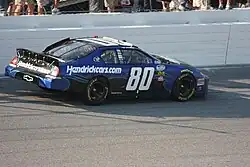 A right-hand side of a black race car with the number 80